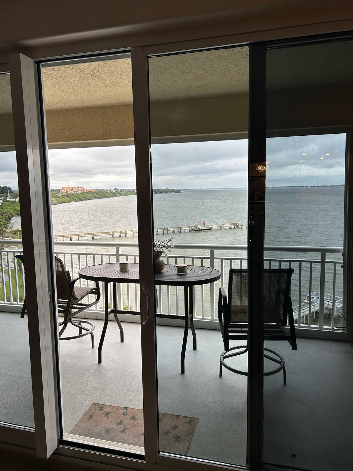 Sliding glass door opening onto a waterfront balcony — sliding glass door services in Melbourne, Florida