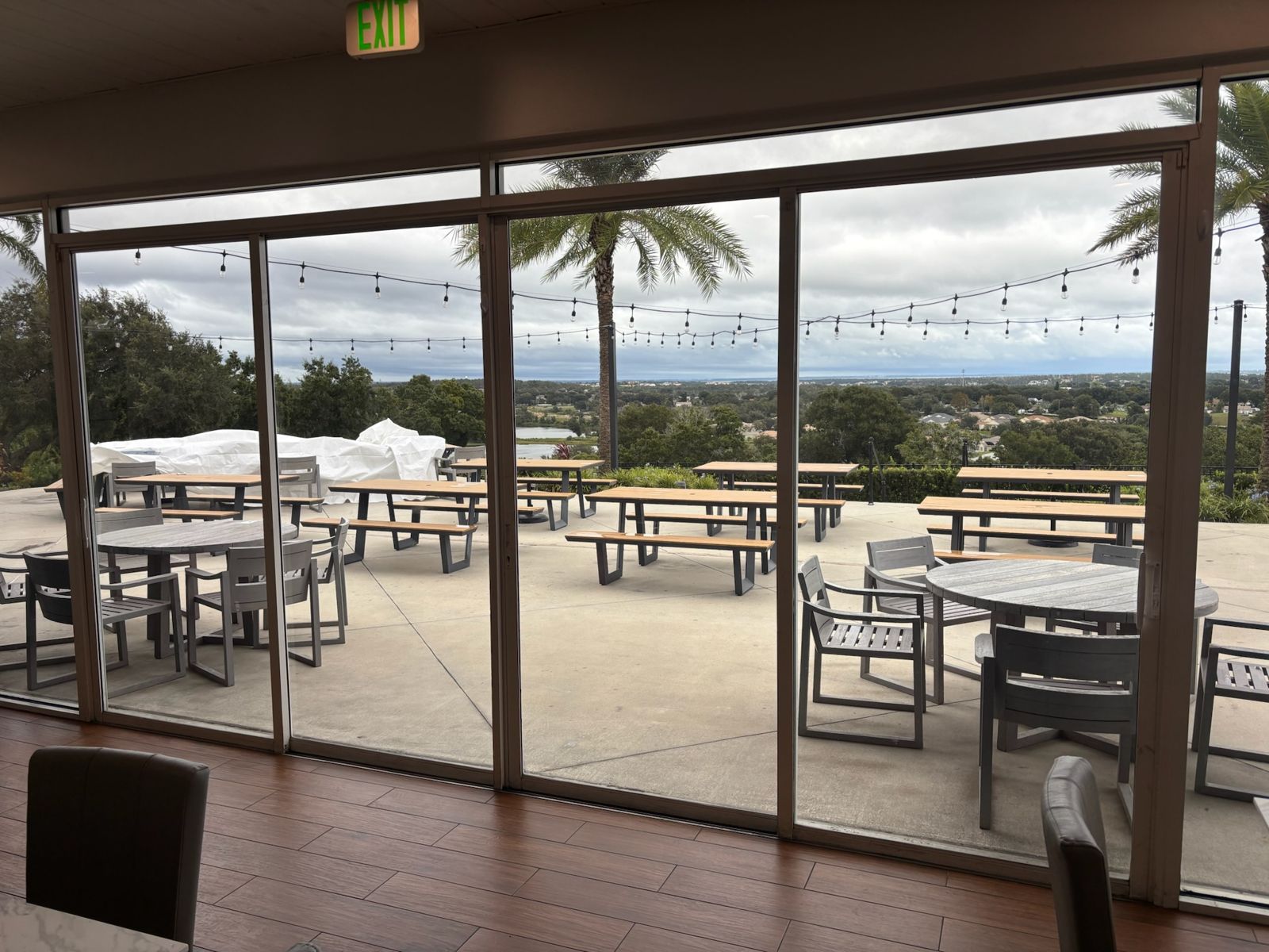 Wide sliding glass doors opening onto a palm-lined coastal patio — sliding glass door services in Merritt Island, Florida