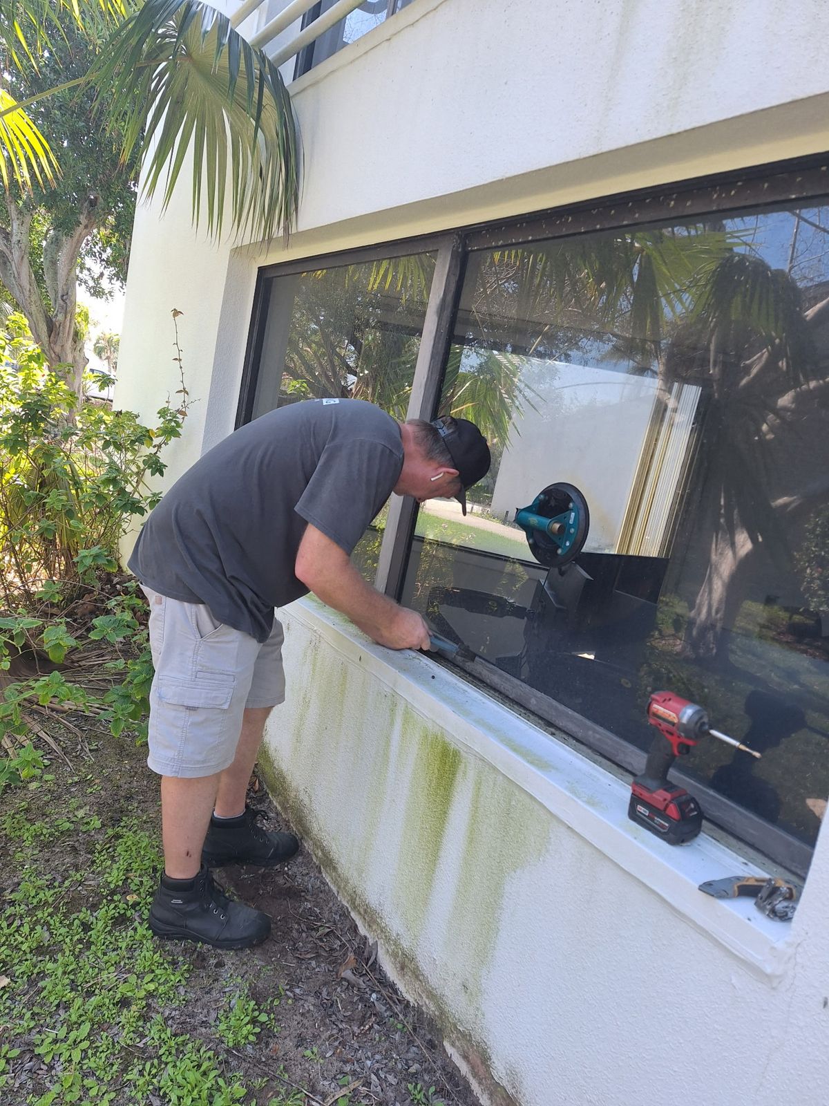 Technician repairing a sliding glass door at a Central Florida home — sliding glass door services in Orlando, Florida
