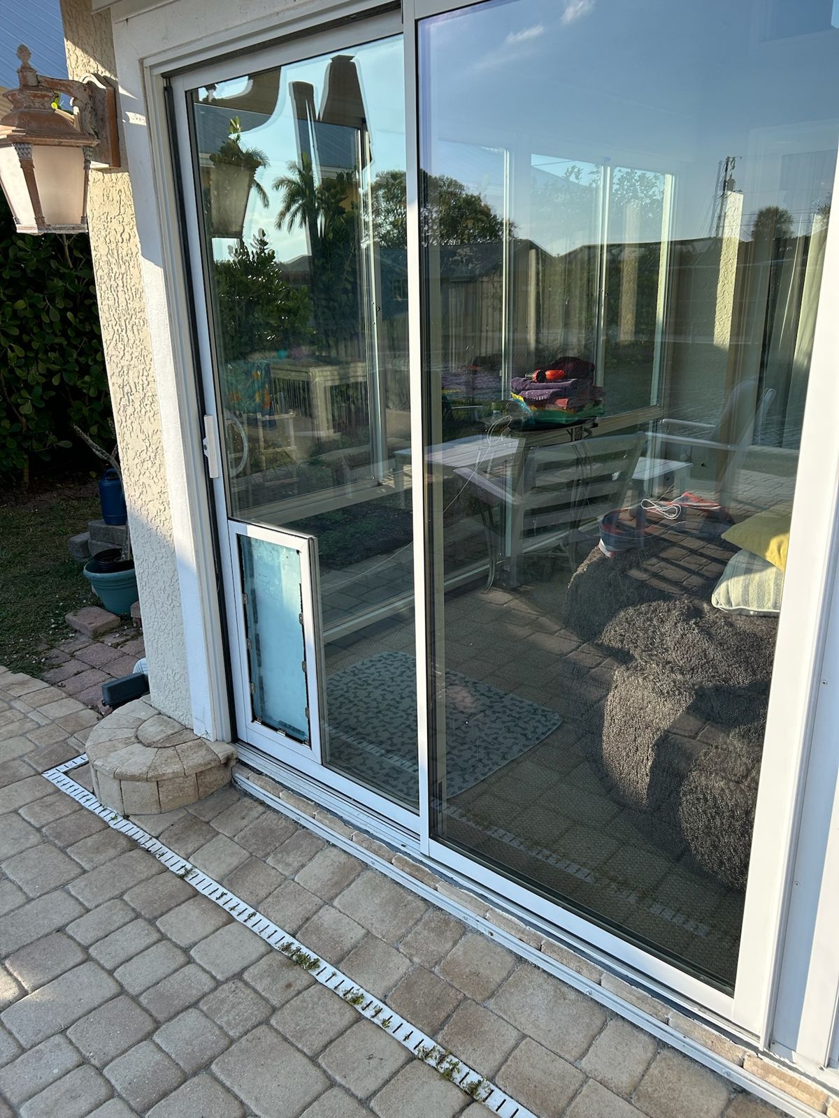 Sliding glass door with new glass installed at a paver patio — sliding glass door services in St. Cloud, Florida