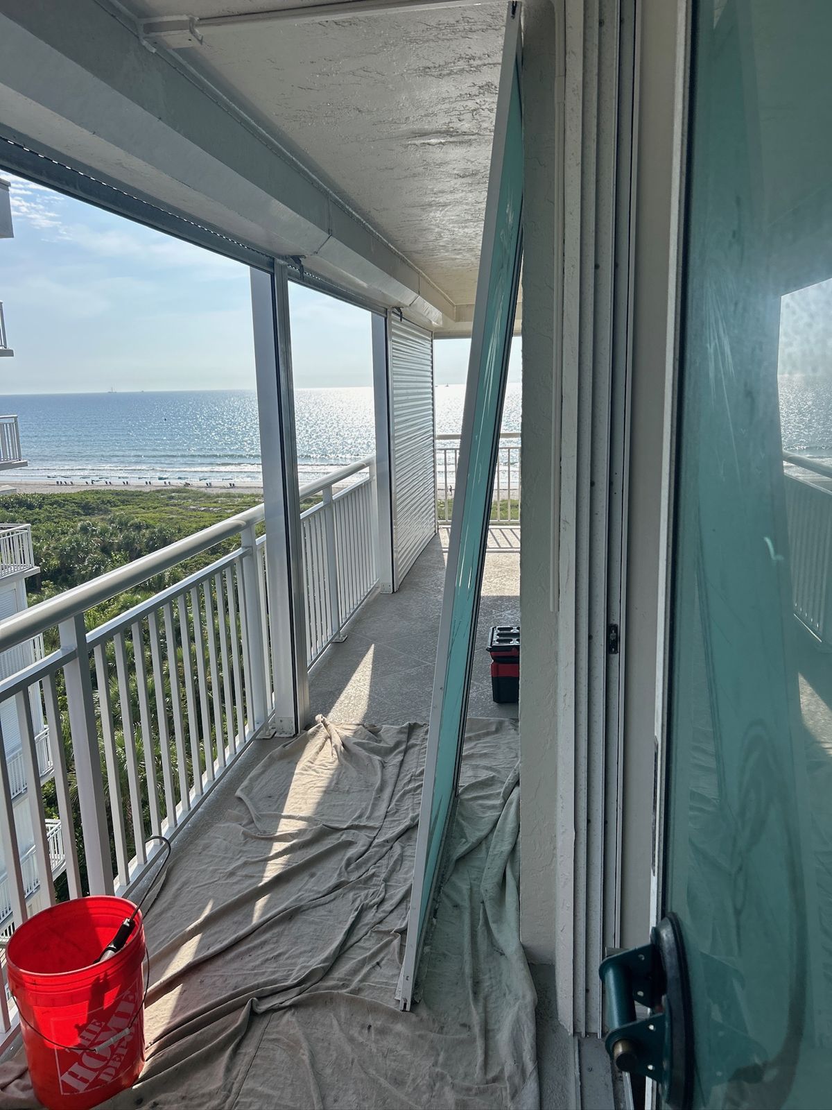 Sliding glass door panel removed on a beachfront balcony — sliding glass door services in Cape Canaveral, Florida
